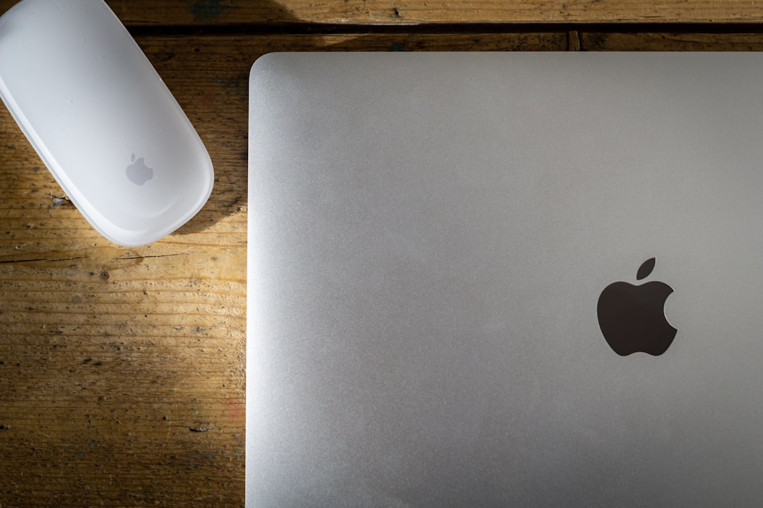 silver macbook on brown wooden table apple devices task list clean workspace