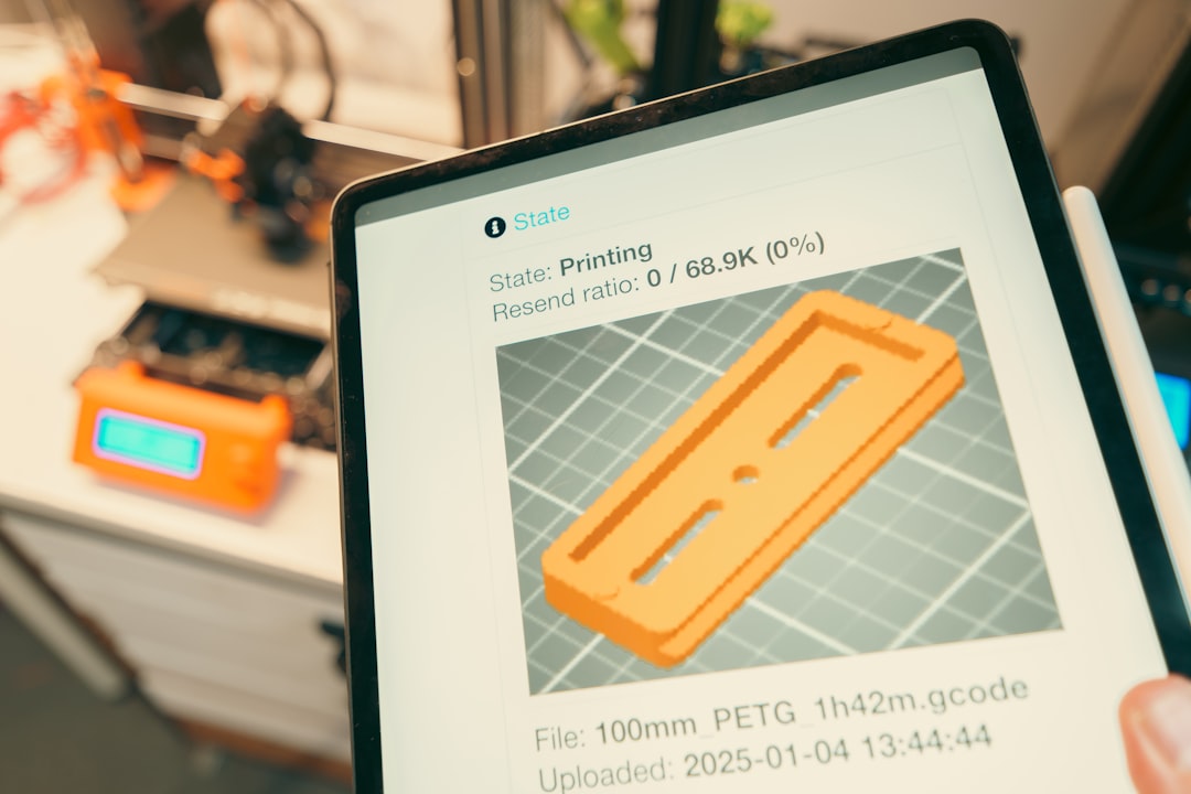 tablet displaying 3d print progress with printer in background cad software comparison laptop design engineering tools 3d models
