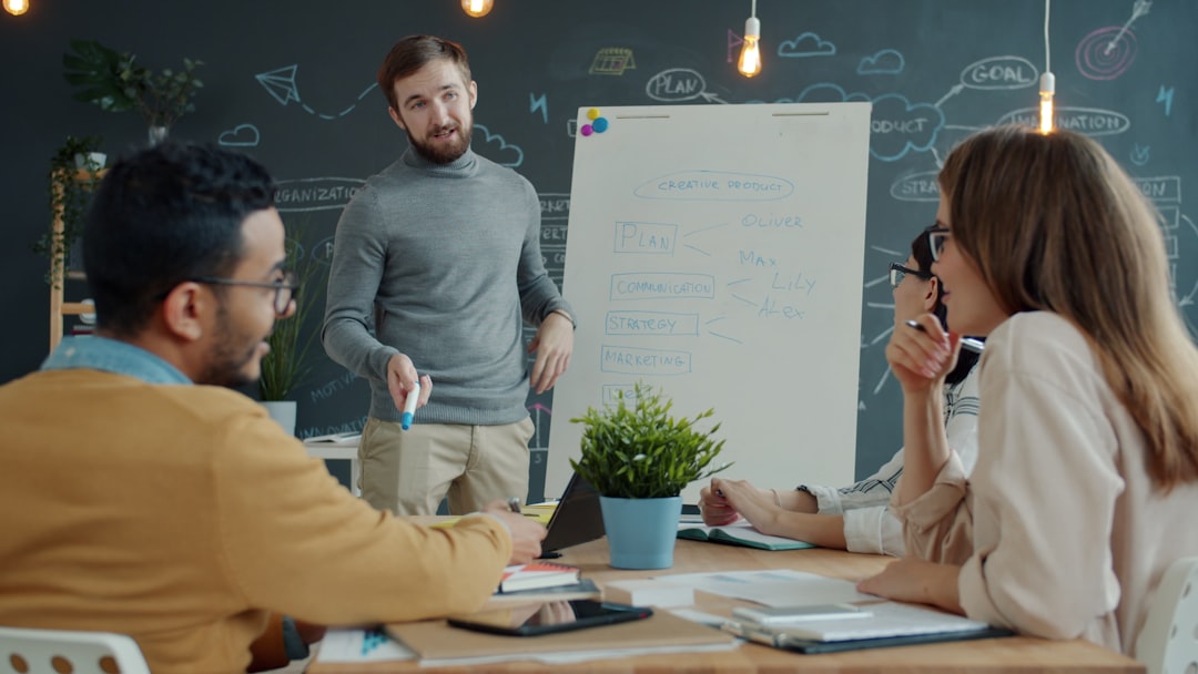 team collaborating around a whiteboard during a meeting company meeting team presentation office audience