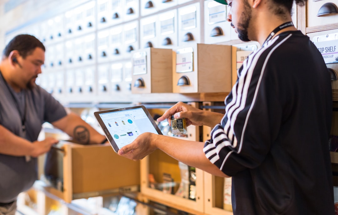 two men in a store looking at a tablet multichannel sales marketplace orders inventory sync