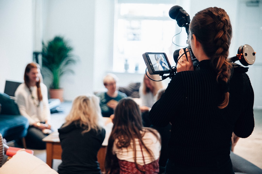 woman holding camera standing near people voiceover recording subtitles elearning video