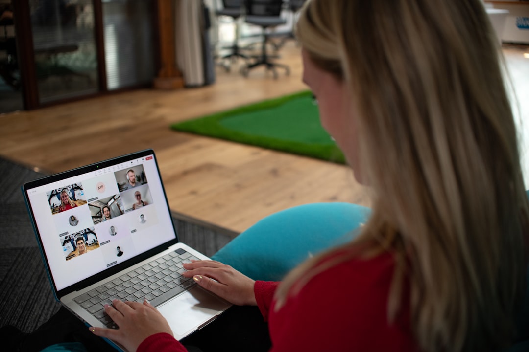 woman using a laptop with video conference on screen webinar registration online presentation laptop audience