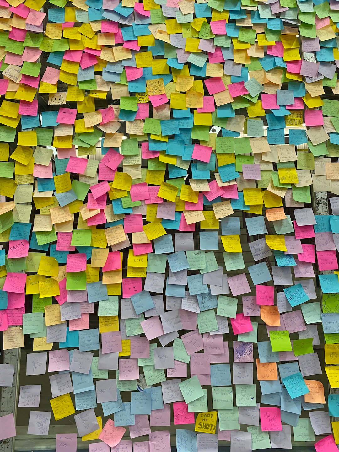 a large amount of post it notes on a wall content planning topic clusters sticky notes