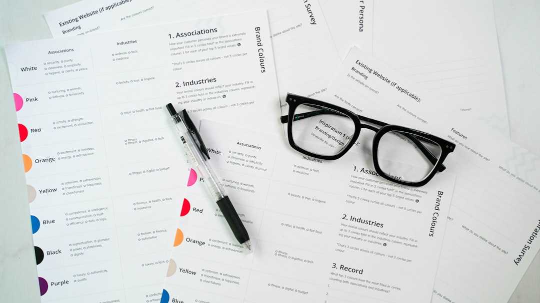 a pair of glasses sitting on top of a pile of paper job application resume upload hiring workflow
