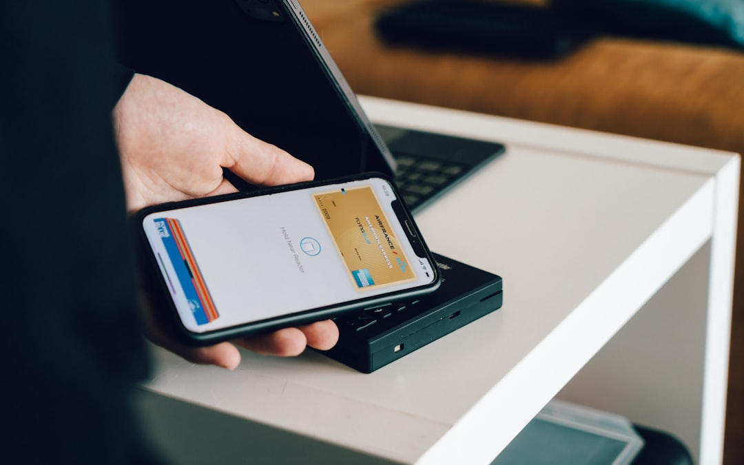 a person holding a smartphone over a card reader for contactless payment smartphone wallet digital pass secure payment travel app