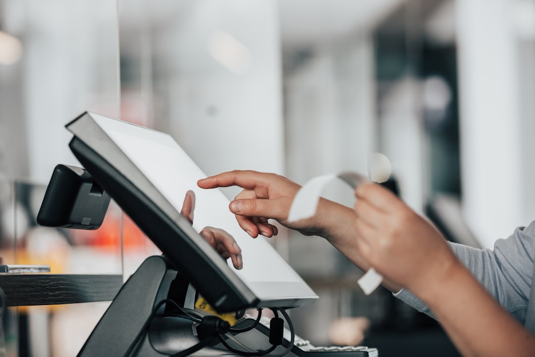 a person is using a pos machine in a store pos comparison payment terminals small business technology