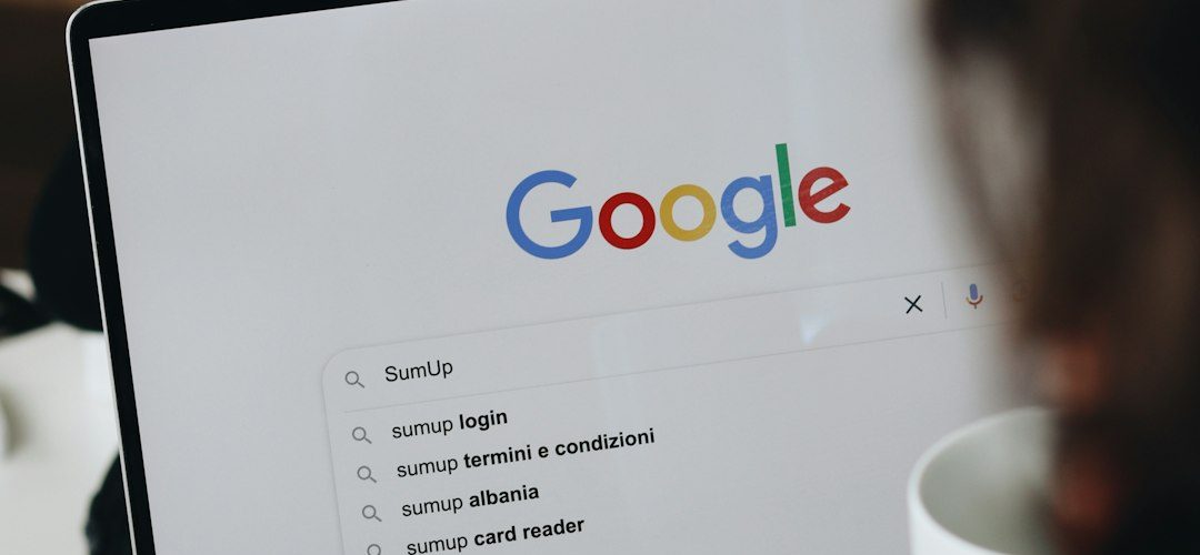 a person sitting in front of a laptop computer google search results related searches keyword research