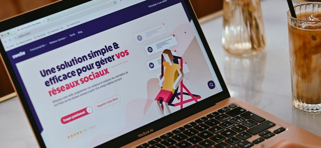 a person using a laptop on a marble table with iced coffee and flowers online store team ecommerce planning brand growth