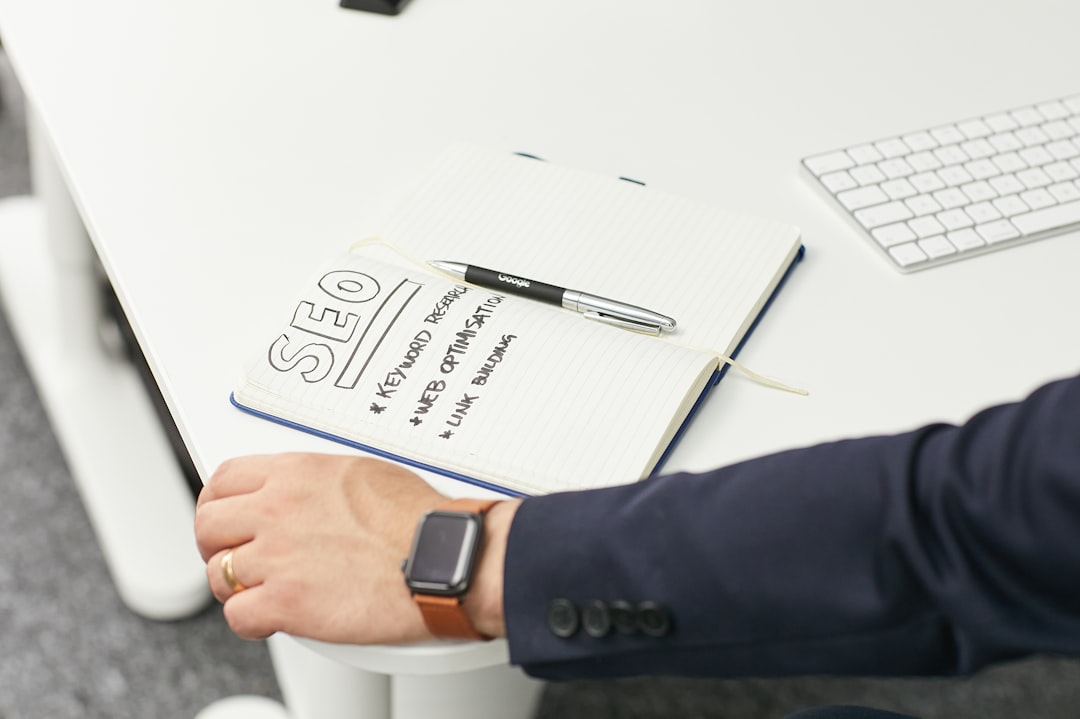 a person writing on a piece of paper seo brief keyword research content calendar