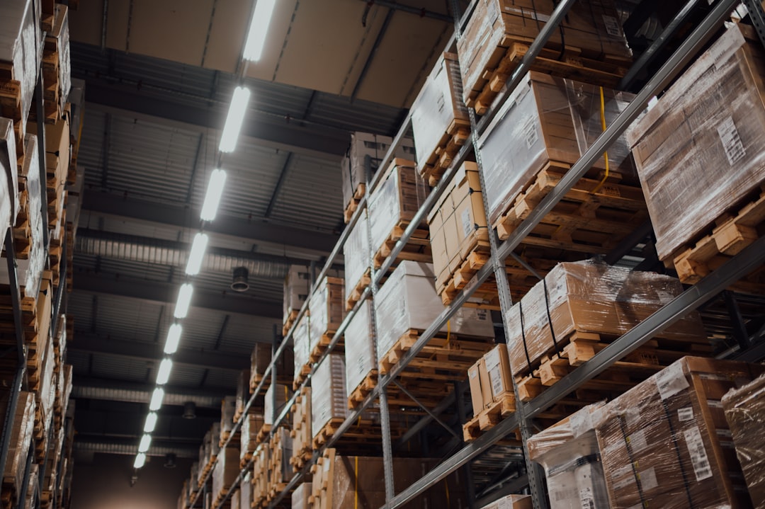 brown cardboard boxes on white metal rack logistics dashboard shipment tracking supply chain visibility