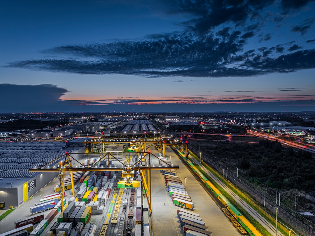 busy shipping port with cranes and containers at dusk global freight network digital map transportation analytics