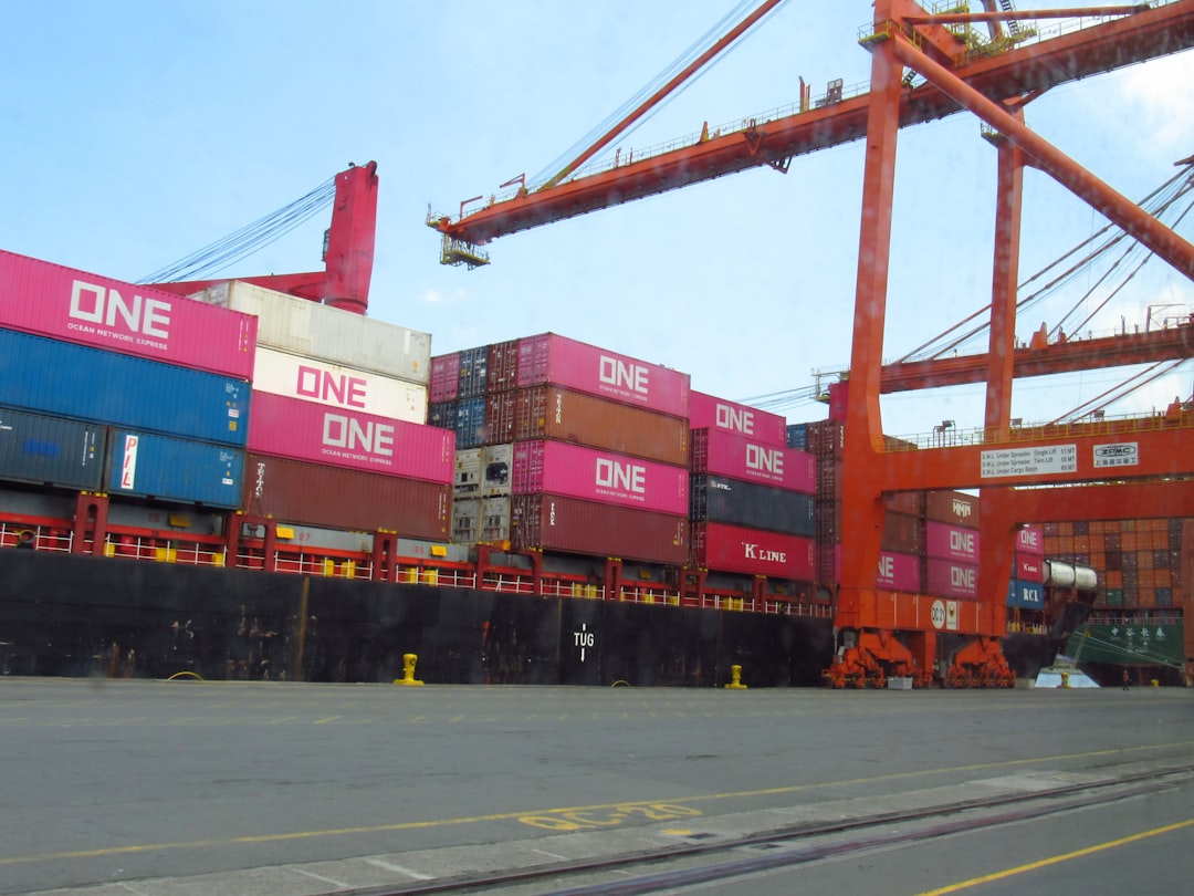 cargo ship loaded with containers at a port global freight network cargo routes supply chain map