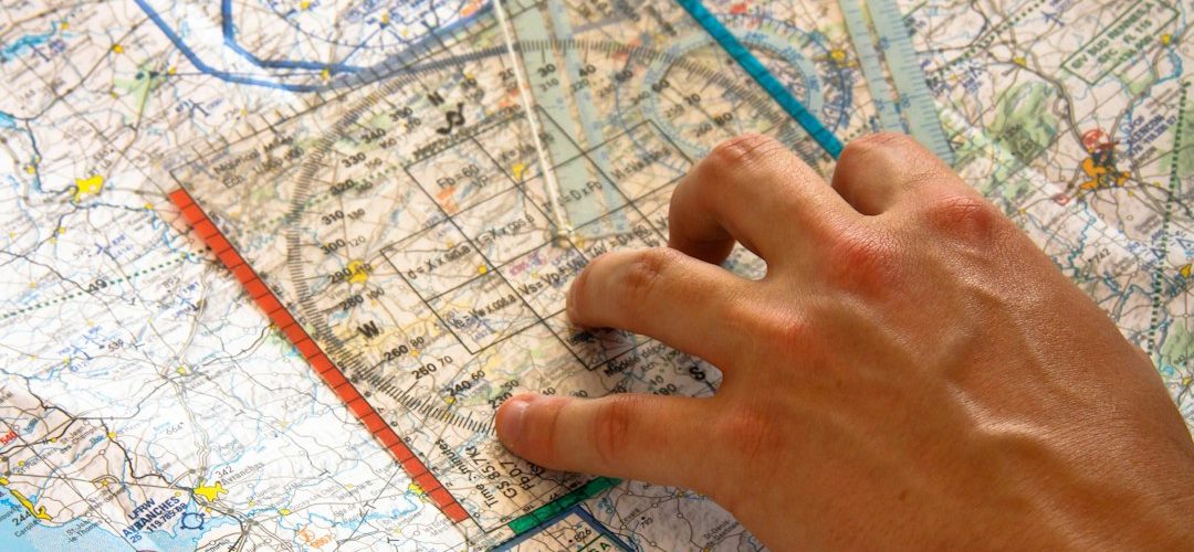 hand using ruler on aviation chart freight tracking dashboard logistics map shipment visibility