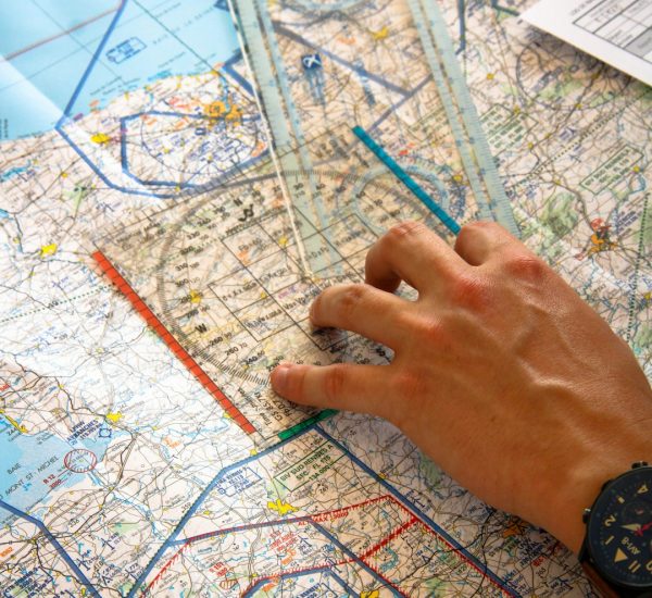 hand using ruler on aviation chart freight tracking dashboard logistics map shipment visibility