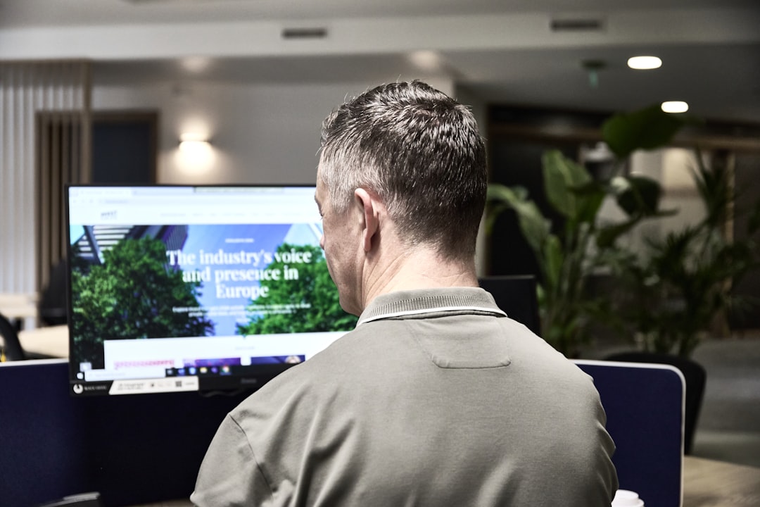 man working on a computer in an office customer support team help desk agents global service 1