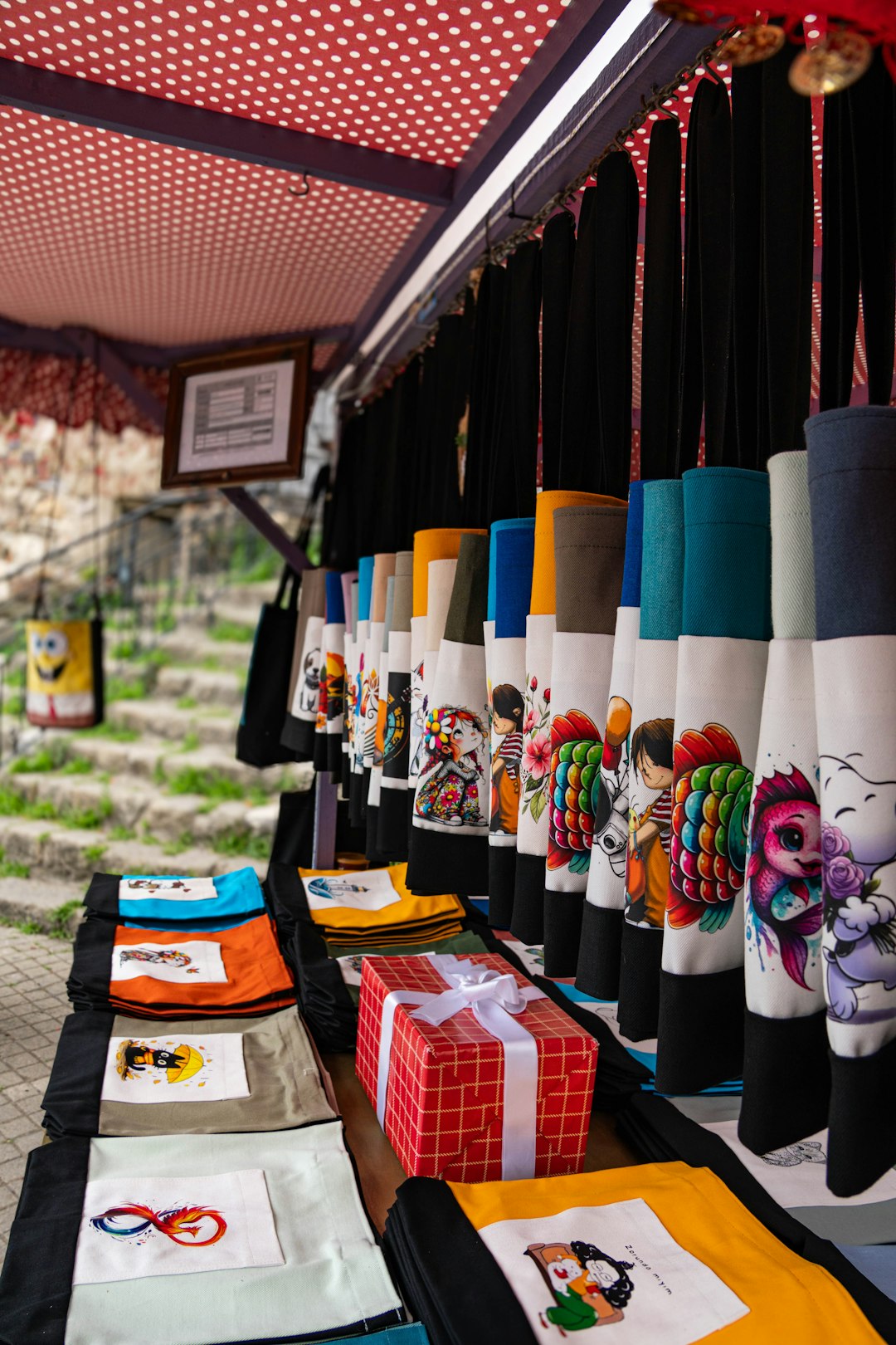 market stall displaying colorful handcrafted aprons and fabric items market stall handmade products happy customer entrepreneur