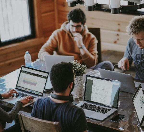 How Coding Automation Can Speed Up Software Development 10 men sitting in front of their laptop computer case workflow automation team collaboration
