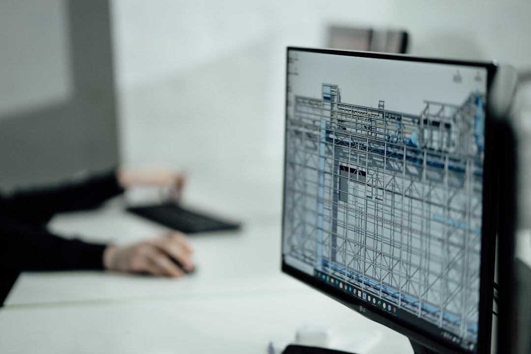 person at desk viewing monitor factory planning dashboard production schedule capacity chart
