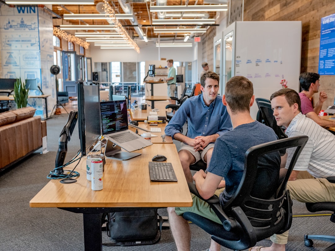 three men sitting on chair beside tables case workflow automation team collaboration 1