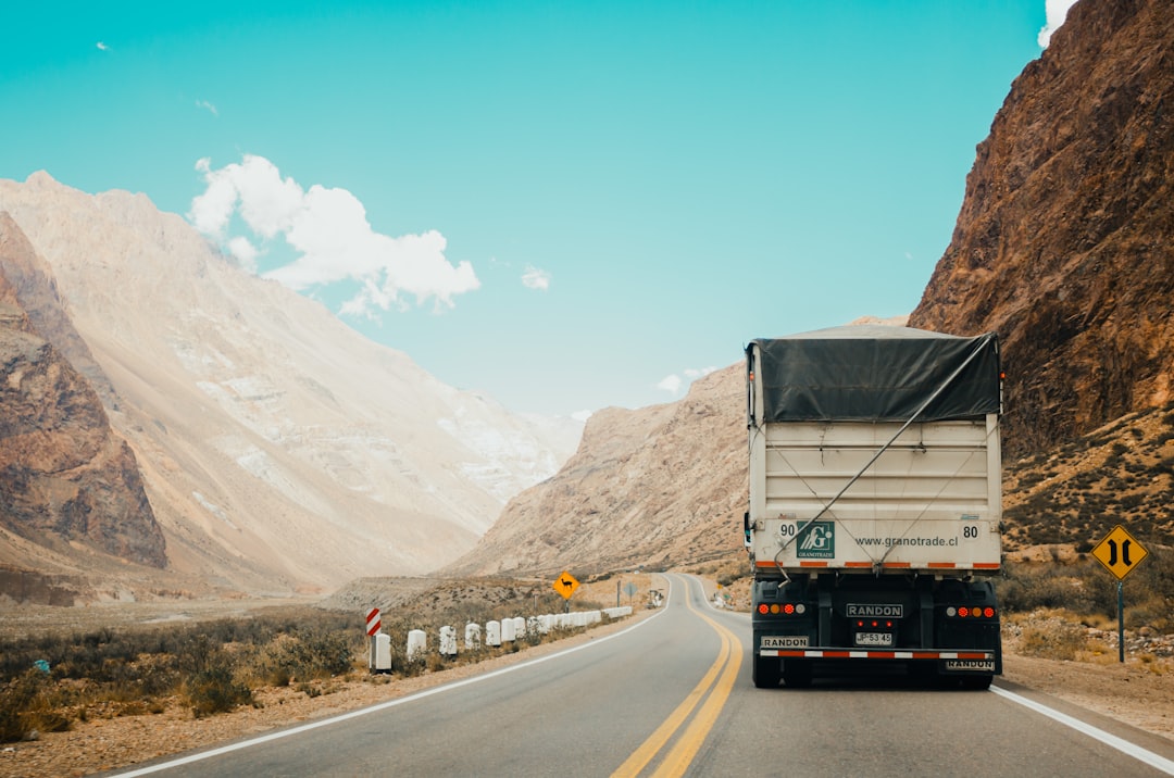 white and black truck near mountain at daytime transportation dashboard shipment tracking logistics analytics