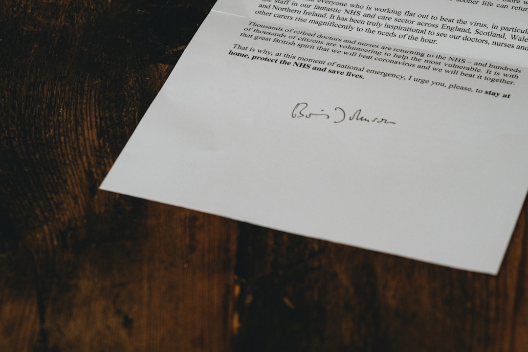 white printer paper on brown wooden table business letter signature company letterhead