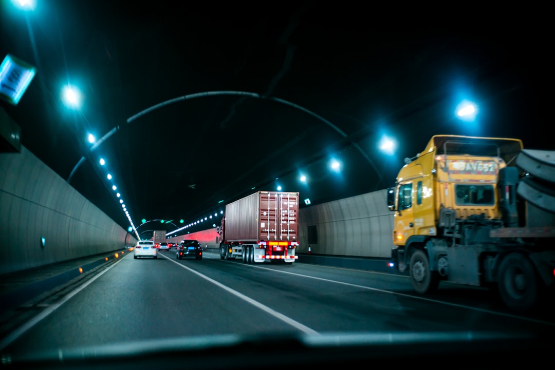 yellow truck on road during nighttime transportation integrations api connections logistics software