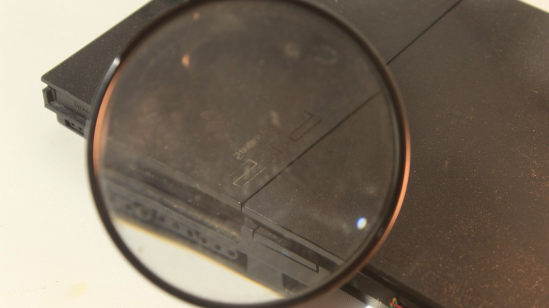 a close up of a magnifying glass on a table dvd player movie night clean disc