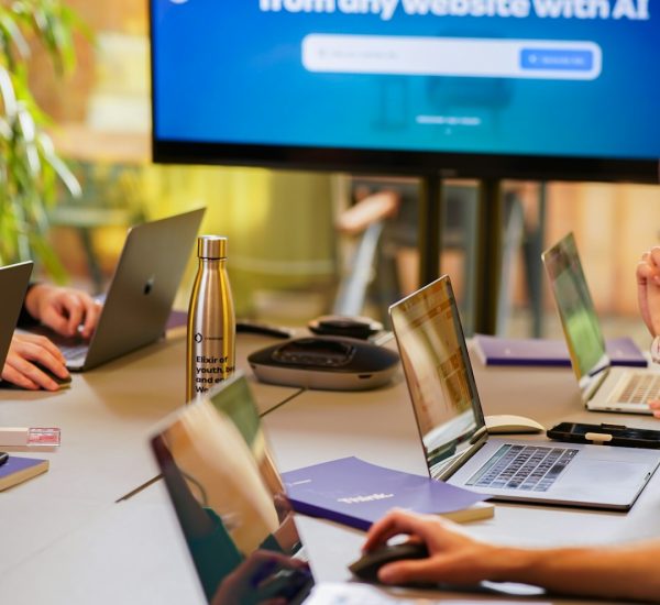 PR Tips: Muck Rack vs Cision for Improving Public Relations 8 a group of people sitting around a table with laptops hospitality marketing team email strategy guest data