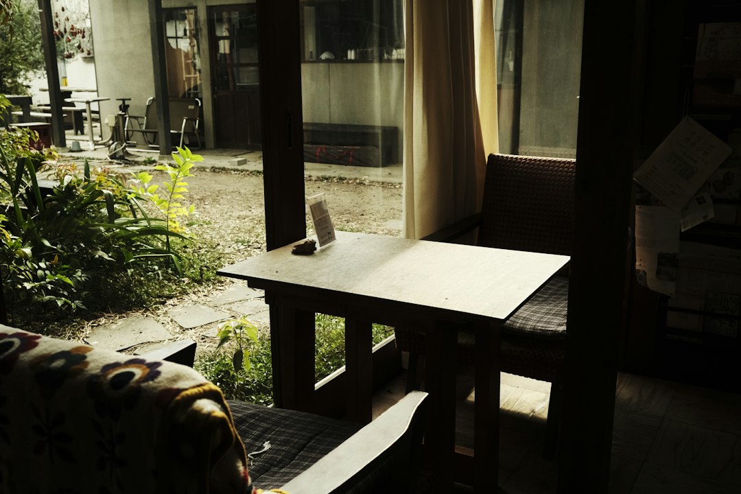 a living room with a couch and a table homestay room cozy bed morning light travel stay 1
