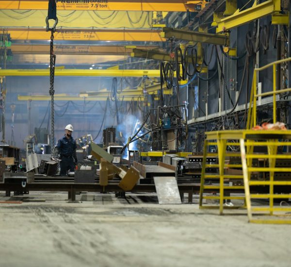 CNC Operator: 8 Skills Every CNC Operator Needs for Success 26 a man standing in front of a machine in a factory cnc machine operator control panel metal shop