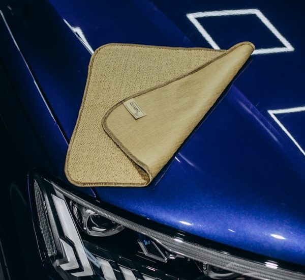 How Can You Fix Scratched CDs: Practical CD Scratch Repair Methods, Cleaning Techniques, and Ways to Protect Discs 8 a microfiber cloth rests on a shiny blue car scratched cd microfiber cloth bright light