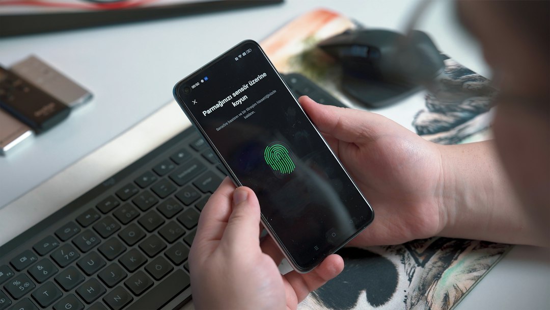 a person holding a phone device login user code mobile approval