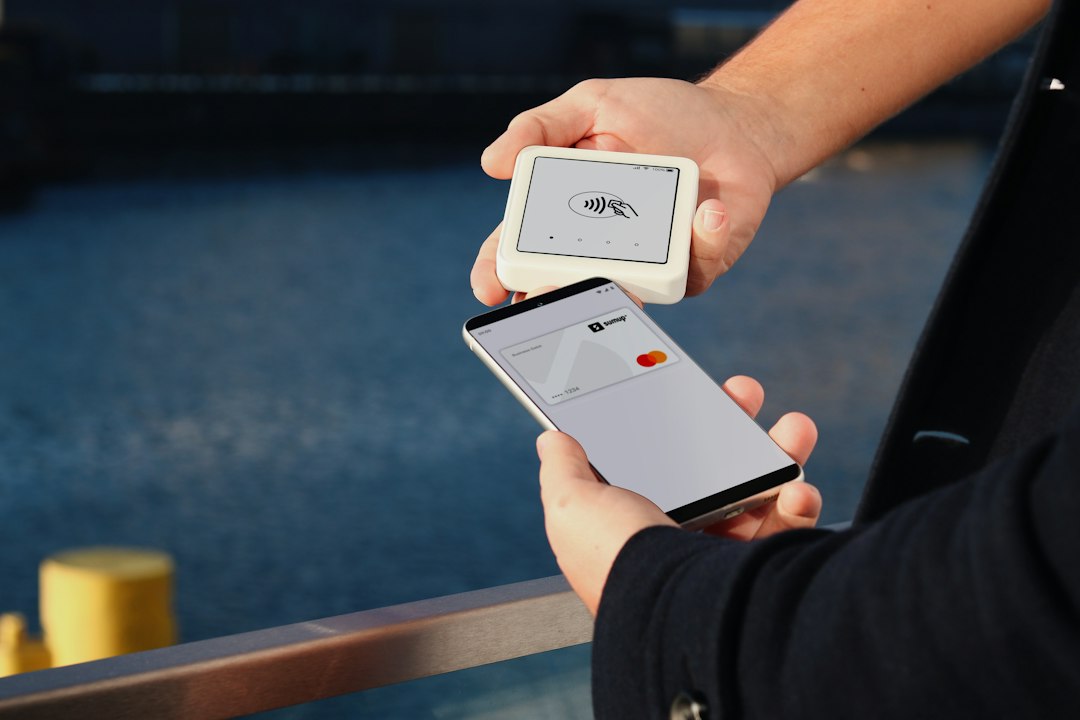 a person holding a smart phone in their hand smartphone wallet digital pass secure payment travel app