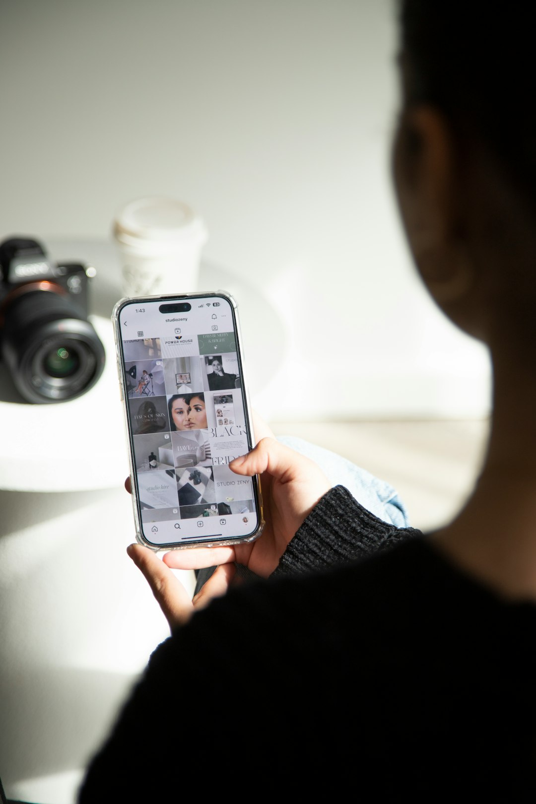 a person holding up a cell phone with pictures on it phone video analytics social media metrics booking messages content planning