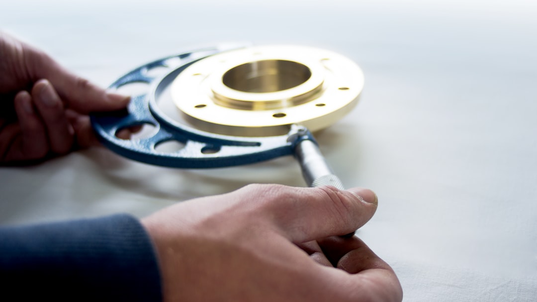 a person is working on a metal object precision measuring tools micrometer caliper machined part