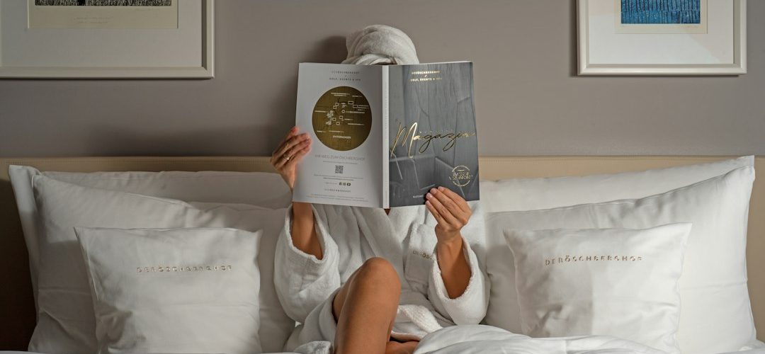 a person reading a book on a bed hotel email dashboard guest segments booking campaign