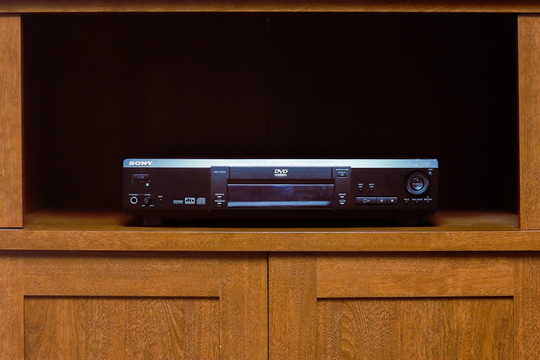 a stereo sitting on top of a wooden shelf dvd player movie night clean disc