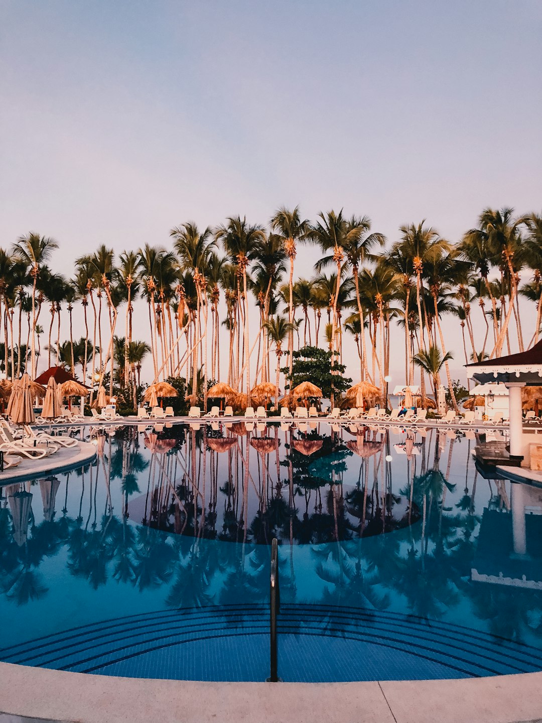 a swimming pool surrounded by palm trees in a resort resort crm workflow sales pipeline guest follow up