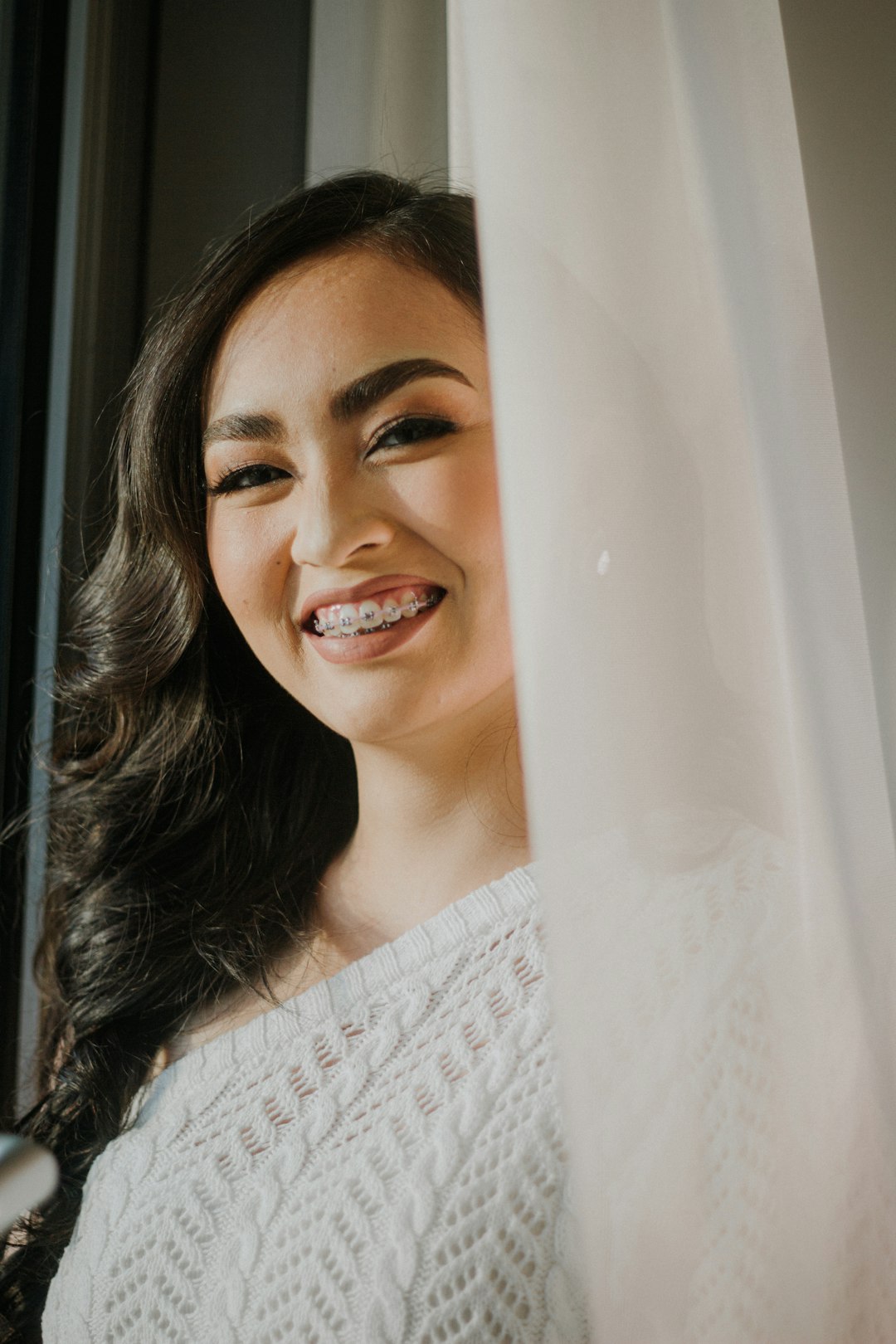 a woman smiling for the camera host greeting guests travel welcome front door warm smile