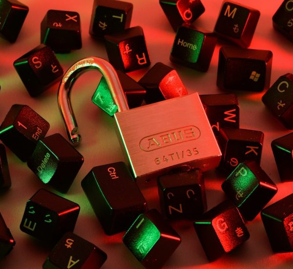 Best Books on Cryptography: Applied Cryptography vs Cryptography Engineering for Learning Encryption 9 an open padlock surrounded by scattered black computer keyboard keys under red and green light vpn security encryption keys remote access