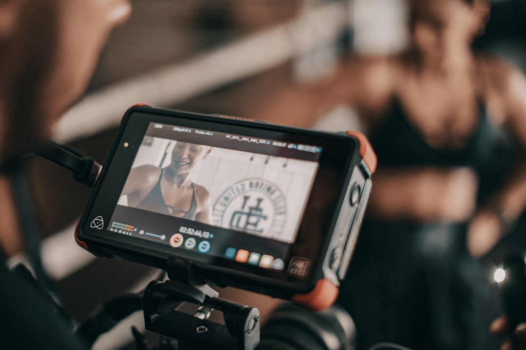 black camera viewing woman smiling fitness coach video post engagement chart