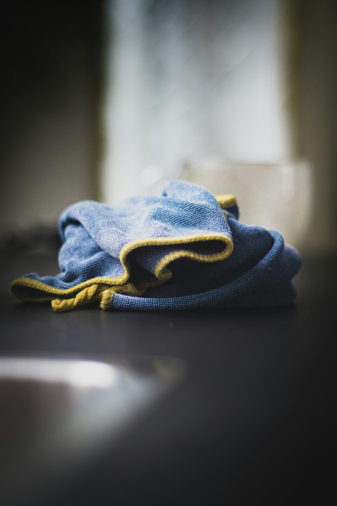 blue denim textile on black table scratched cd microfiber cloth bright light