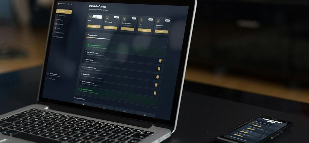 laptop and phone displaying financial data founder building app ai coding product dashboard