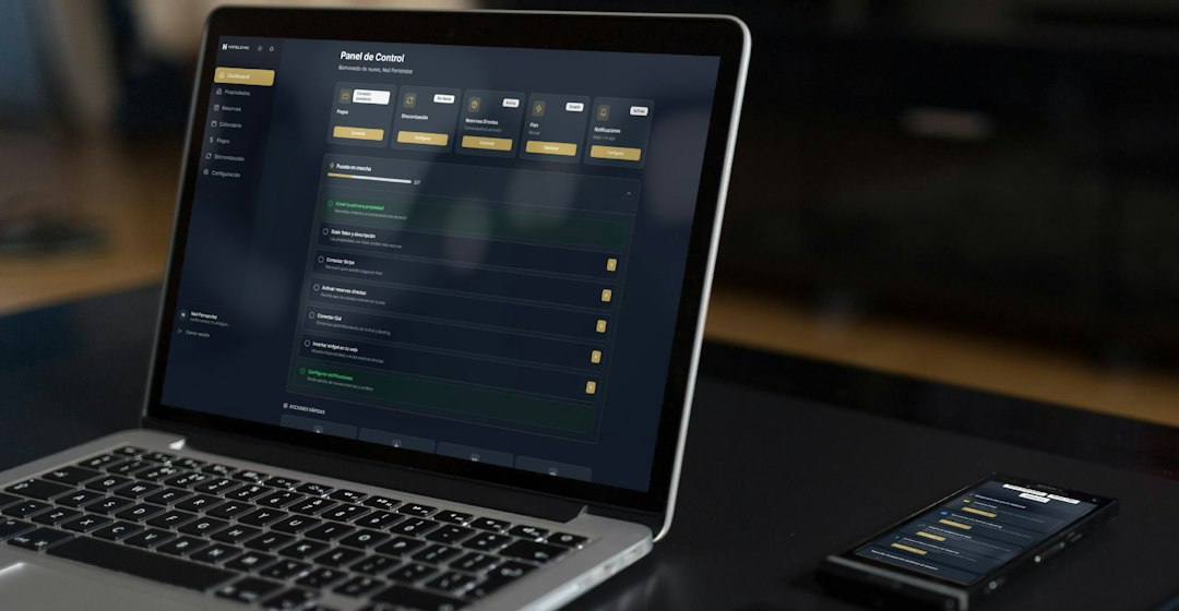 laptop and phone displaying financial data founder building app ai coding product dashboard