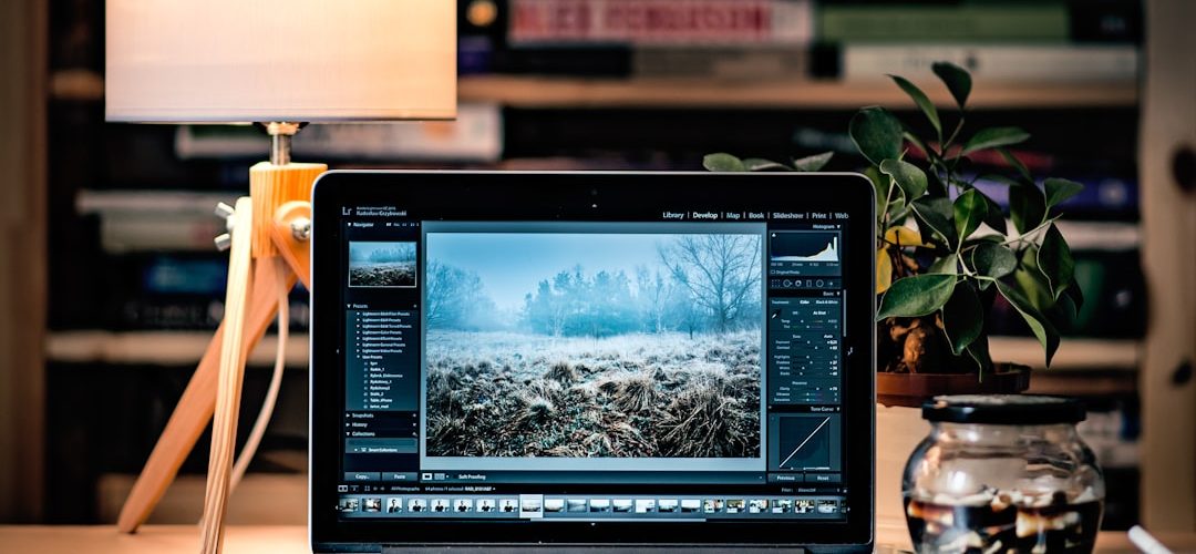 macbook pro on brown wooden table inside room content creator desk laptop editing social video