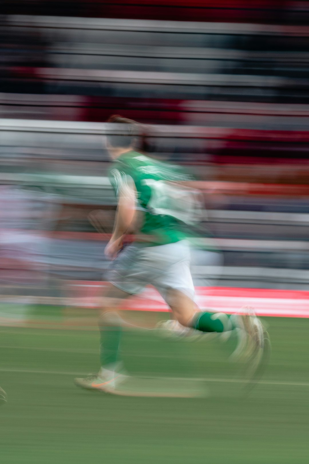 soccer player in green running on field match cut motion blur transition