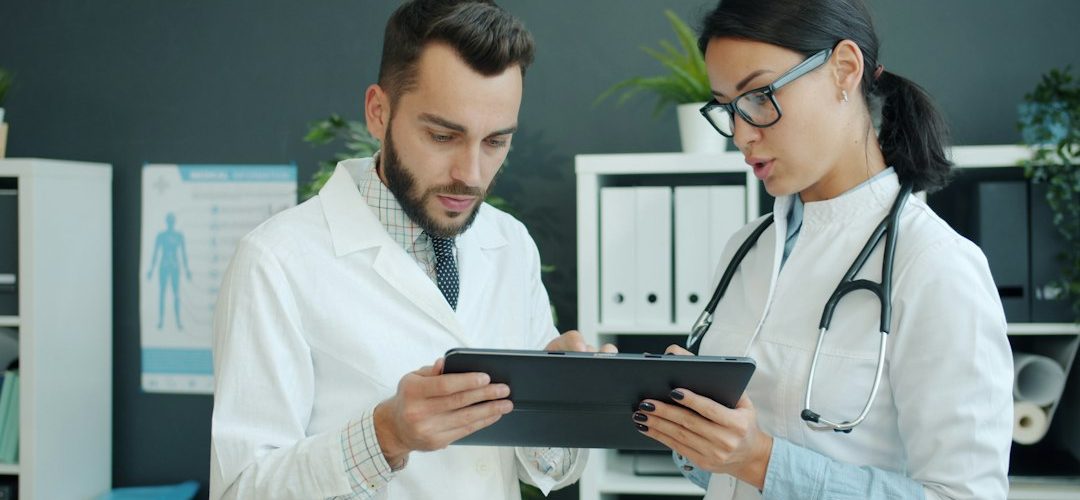 two doctors looking at a tablet together healthcare marketing comparison agency selection medical website analytics