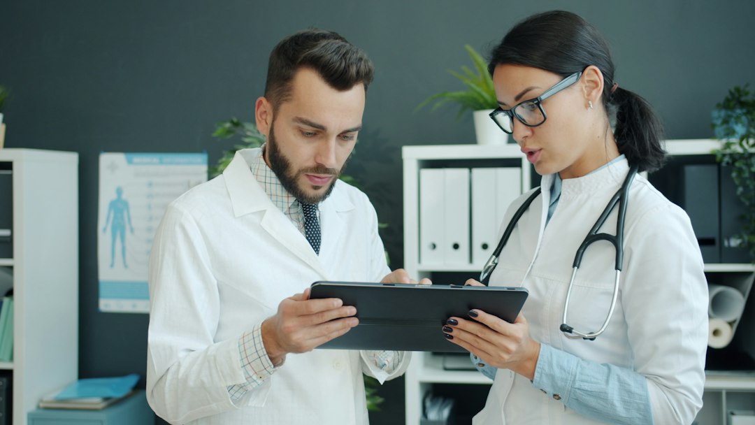 two doctors looking at a tablet together healthcare marketing comparison agency selection medical website analytics