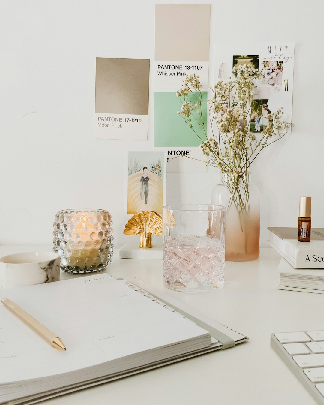 white flowers in clear glass vase on white table designer desk mood board wireframes ui inspiration