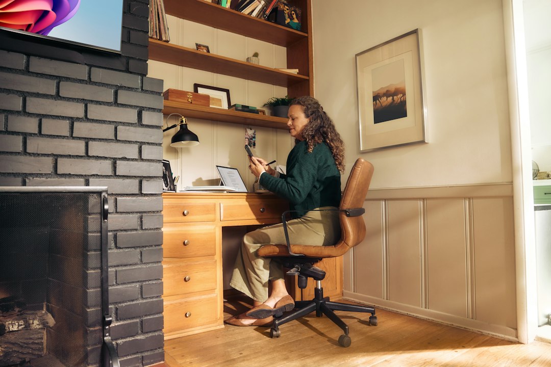 woman working at a desk in a cozy home office remote worker laptop security home office